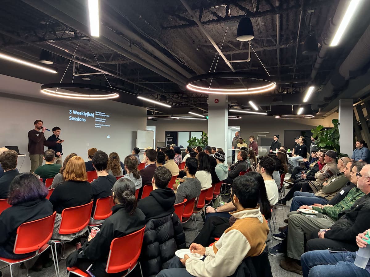 Startup booth at a demo day event with people having conversations